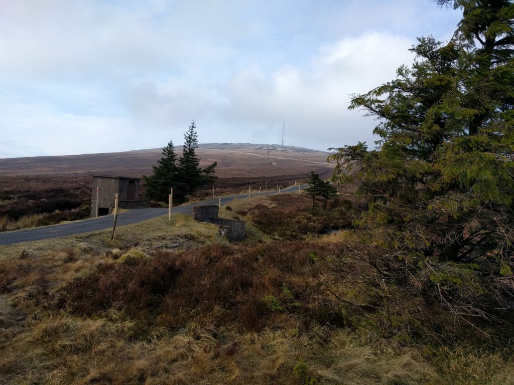 Tarmac road leading up to transmission mast on the hill