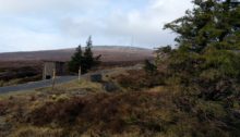 Tarmac road leading up to transmission mast on the hill