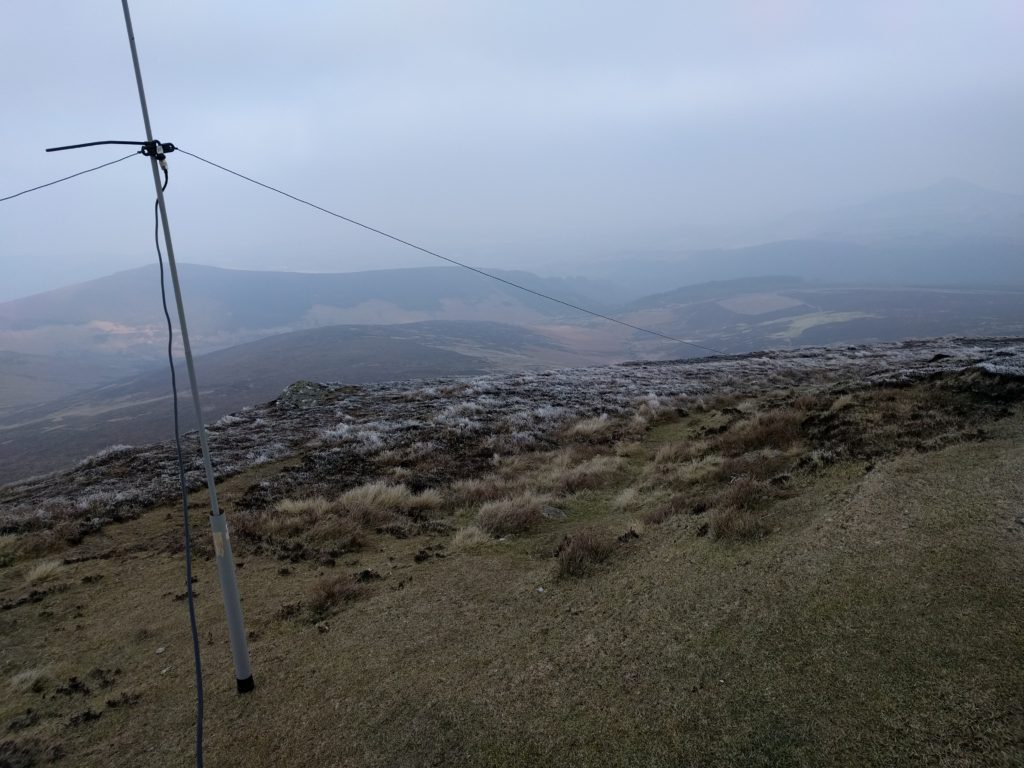 Low fibreglass pole and dipole, with hills in background
