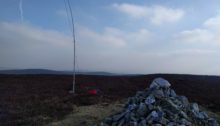 Cairn in foreground, mast in surrounding heather