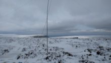 Fibreglass antenna mast standing on snowy ground