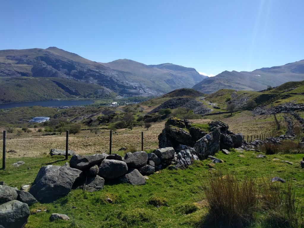 Cut boulders in foreground, mountains in background with deep blue sky