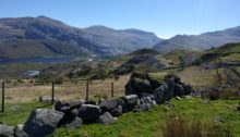 Cut boulders in foreground, mountains in background with deep blue sky