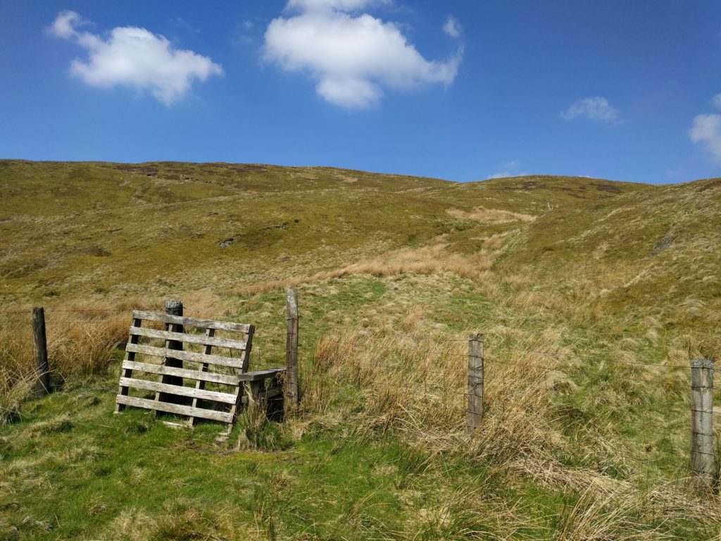 Stile over fence to moorland