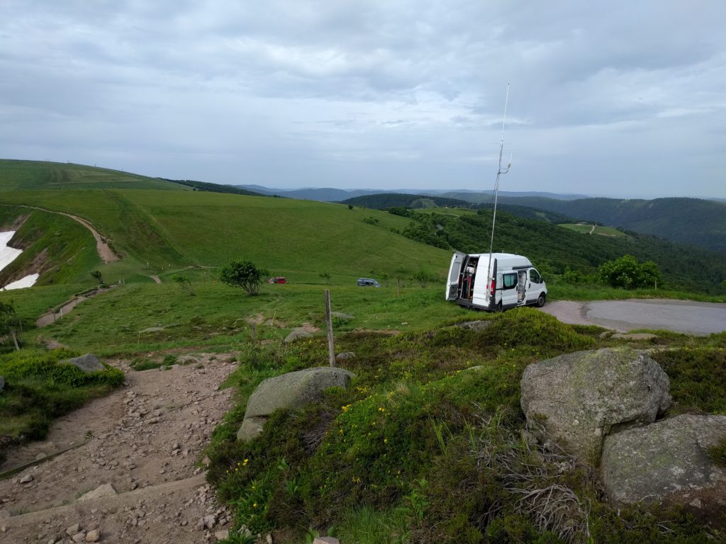 Van with mast parked by the roadside