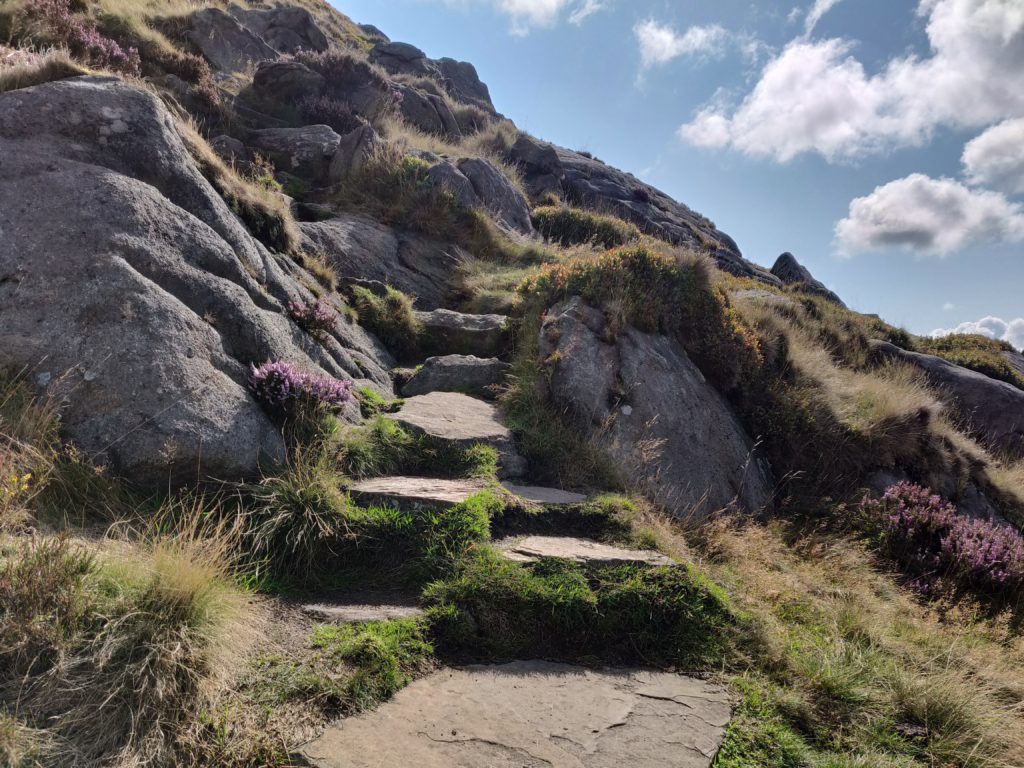 Stone path going up hill, surrounded by boulders