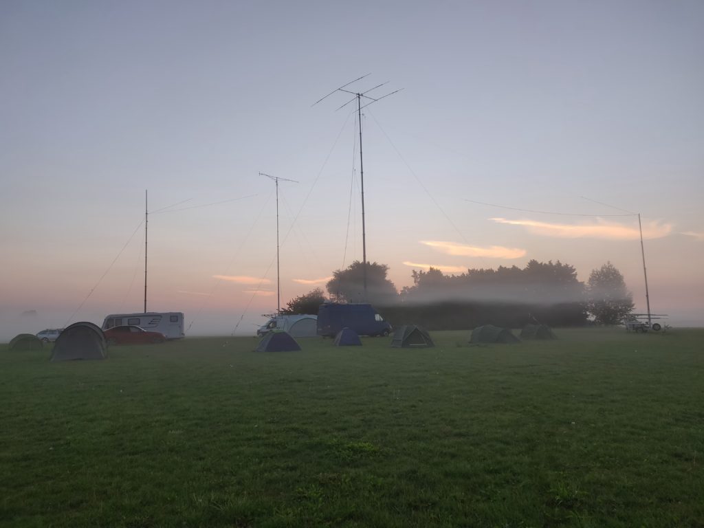 Mist hanging over a field with tents