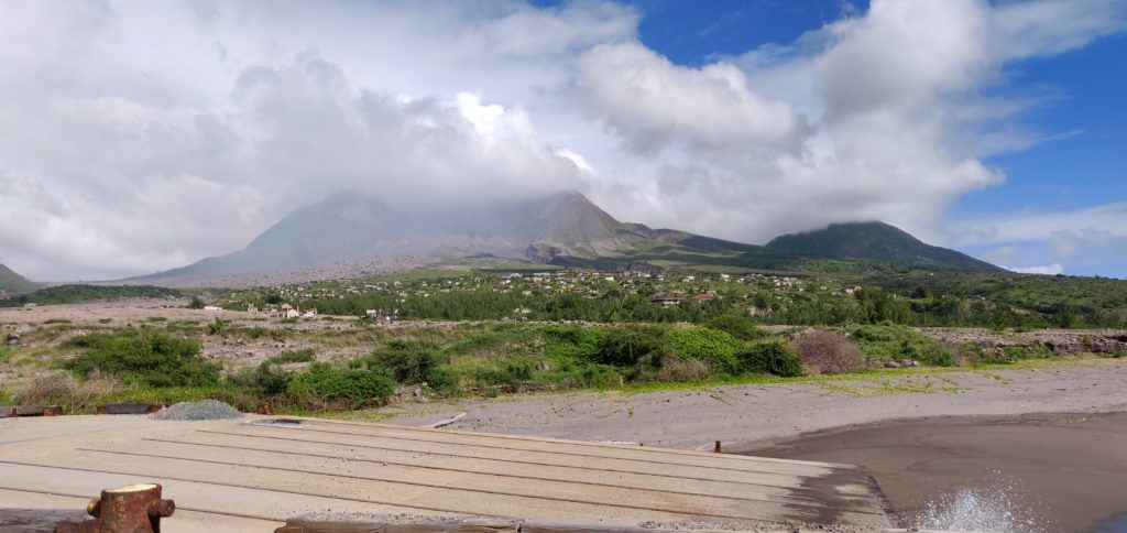 Volcano with abandoned houses in foreground